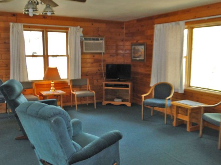 Cozy cabin living room with blue recliners and TV