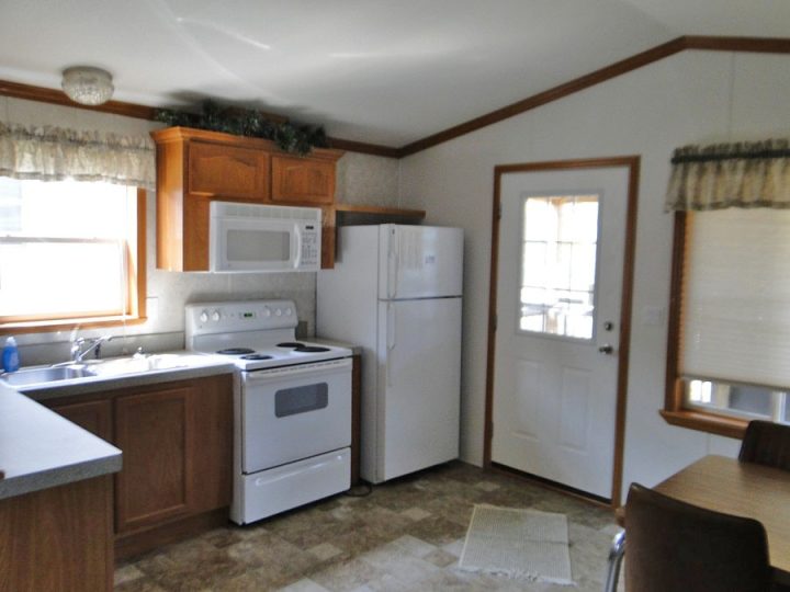 Small kitchen with white appliances and oak cabinets